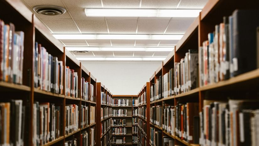 college kerela - a library with book shelves filled with numerous books in view.