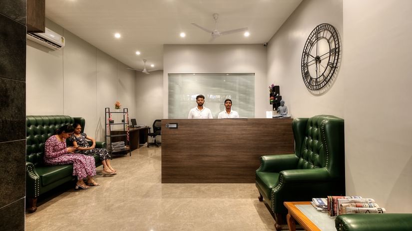 front view of the Reception with a large clock next to the desk - Magnus Fortune House, Magarpatta
