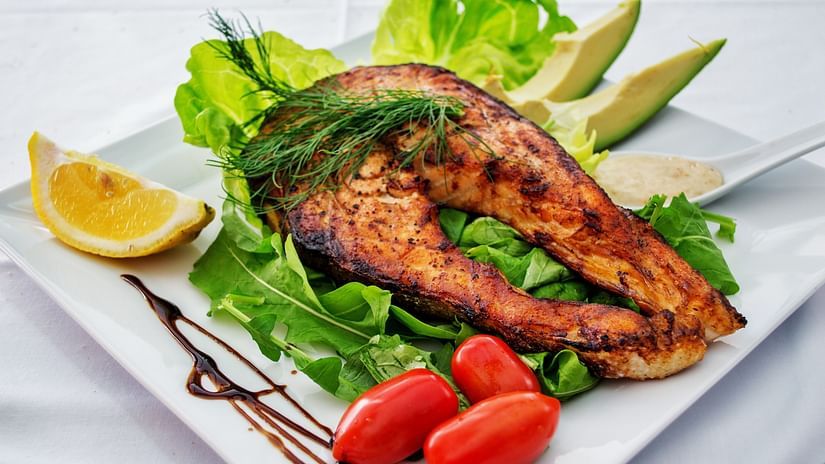 fish starter garnished with cherry tomatoes, lemon slices and lettuce