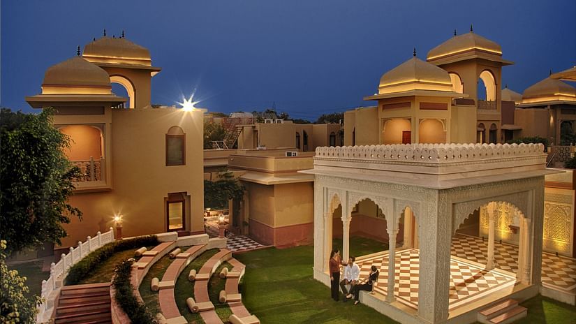  An open-air amphitheatre and traditional pavilion set amidst a serene courtyard at dusk -  Heritage Village Resorts & Spa, Manesar