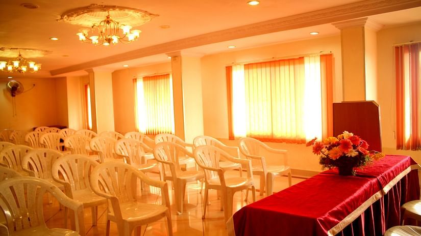  a conference hall at Hotel Swagath Bangalore with a lavish seating arrangement