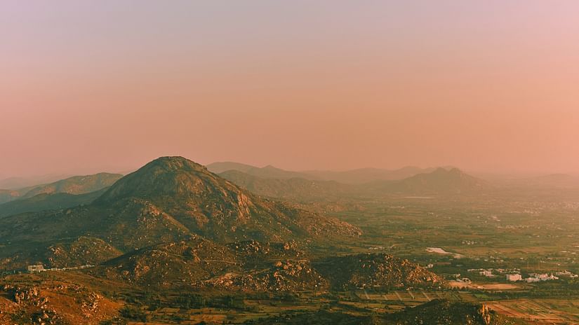 Panoramic view of towering mountains from a hilltop, highlighting the stunning natural scenery and peaceful surroundings.
