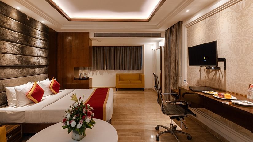 Spacious side view of executive room with a king-size cozy bed and a wall-mounted TV at Icon Premier Hotel by Bhagini, Devarabisanahalli