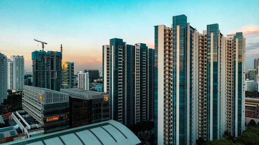 An overview of a city with massive buildings as offices and blue skyline in the background.