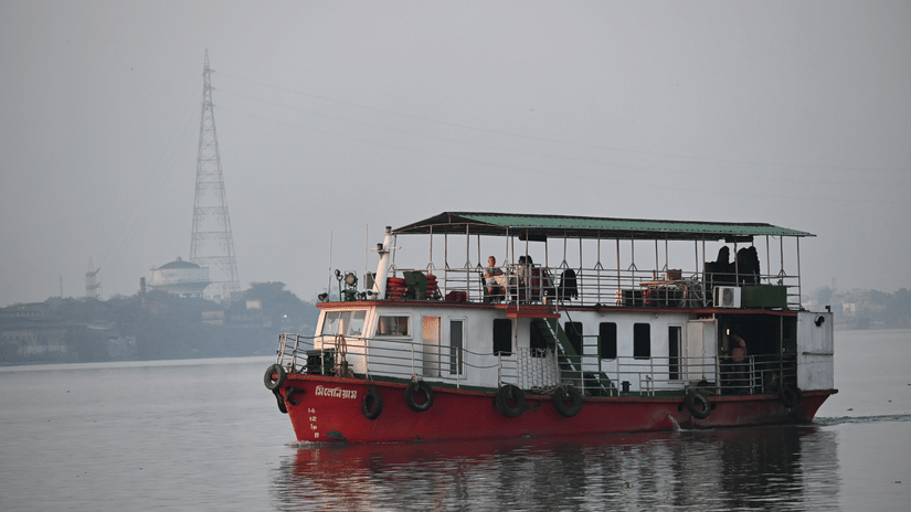 Passenger boat cruising across calm waters during the early morning.
