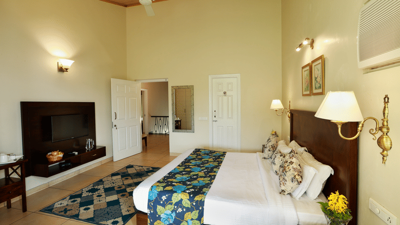 Room with blue comforter at Lamrin Hotels & Resorts