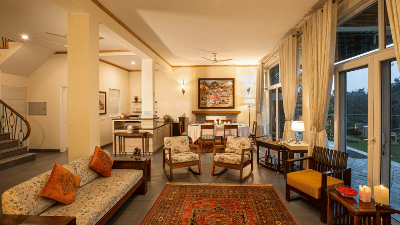 Aesthetically designed living room with painted with pastel hues and features couches facing the outdoor landscapes1 - Lamrin Norwood Green Palampur