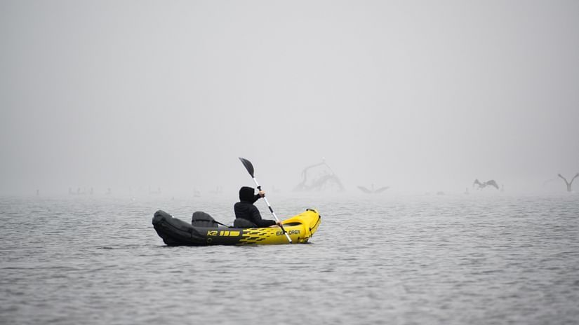 a person kayaking on a river