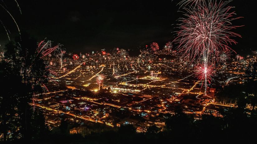 An aerial view of fireworks in a well-lit city at night | New year in Odisha