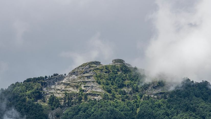 a foggy view of a hill