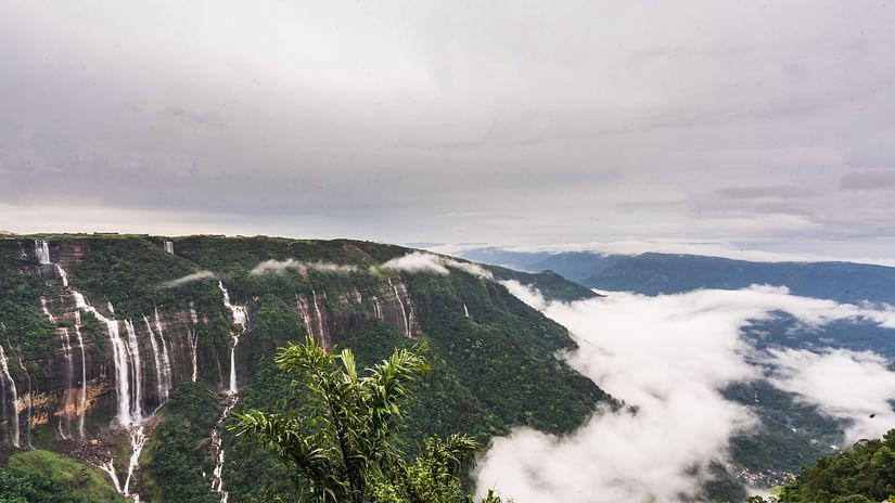 An image of a hill with several waterfalls and the horizon covered with clouds -  Polo Orchid Resort, Cherrapunji