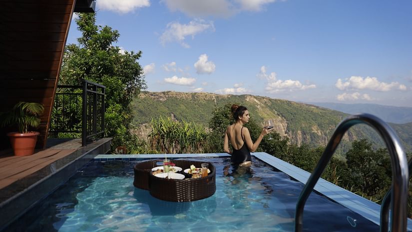 a guest looking out over the pool - Polo Orchid Resort, Cherrapunji