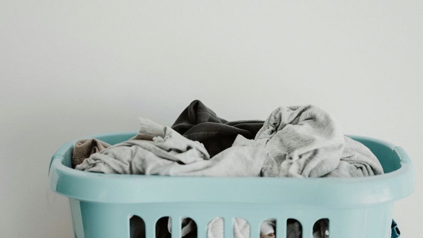 Laundry basket filled with clothes, representing convenient in-house laundry service for hotel guests.