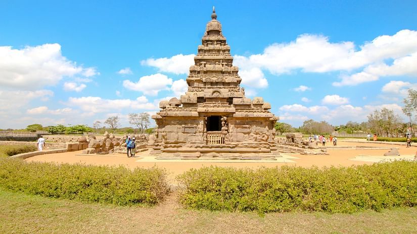 Mahabalipuram temple surrounded by green grass and blue sky in the background