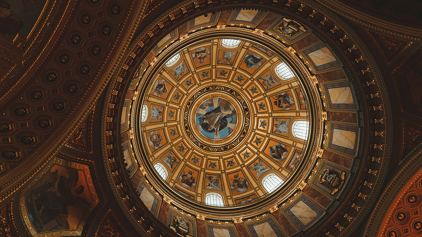 a view of a dome with intricate paintings as seen from below