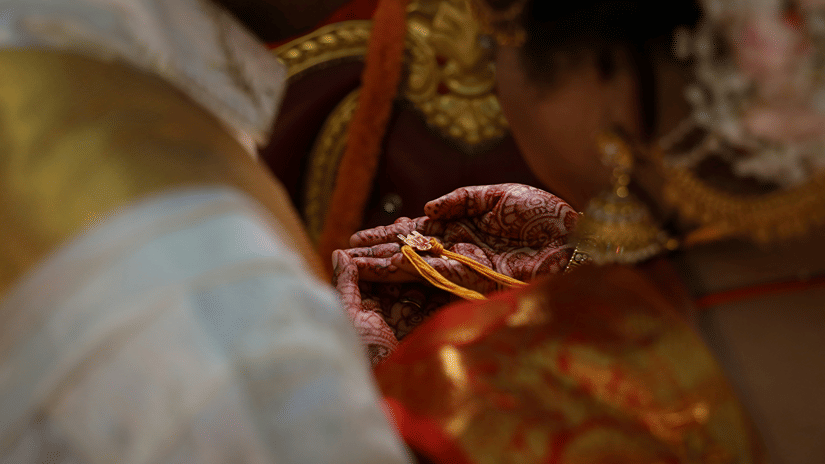 A bride holding the mangalsutra, also known as thali, in her palm