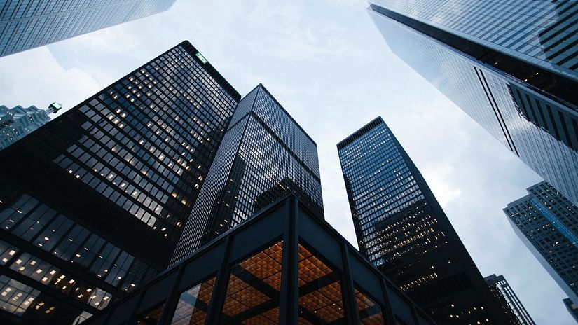 many skyscrapers almost touching the sky as seen from the bottom
