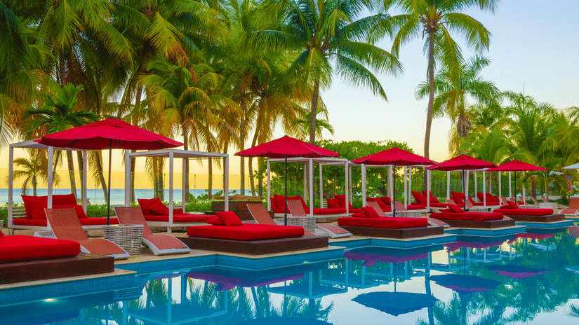 swimming pool with red sun loungers on the deck at S Hotel Montego Bay, Jamaica