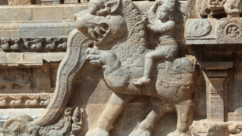 Intricately carved stone sculpture of a mythical lion-like creature adorning an ancient temple, showcasing remarkable craftsmanship and architectural heritage details