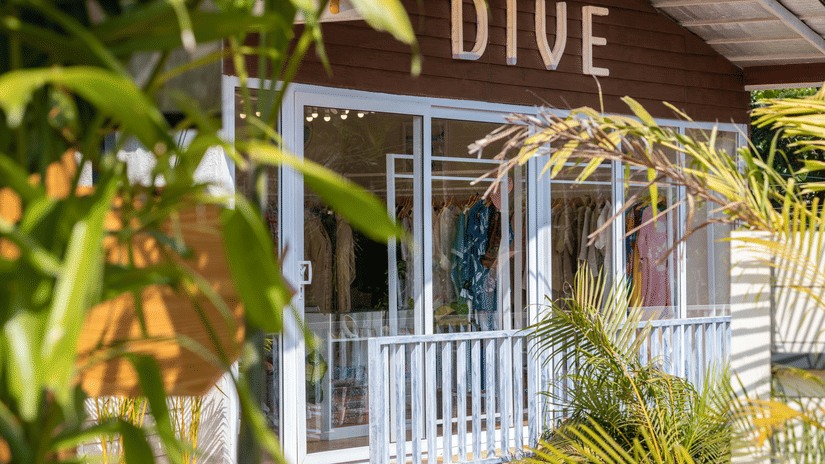 exterior image of the in-house fashion retail outlet surrounded by several plants