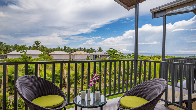 private balcony featuring two chairs along with a coffee table with beautiful views from the balcony