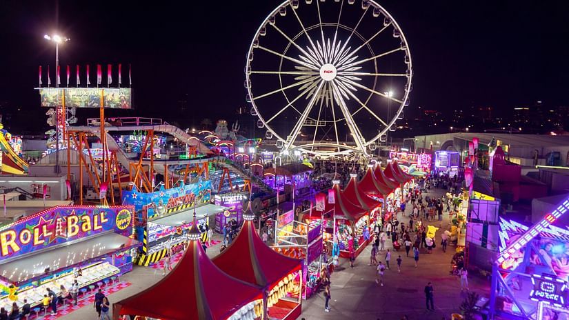 the ferris wheel and other stalls and decorations at a fete
