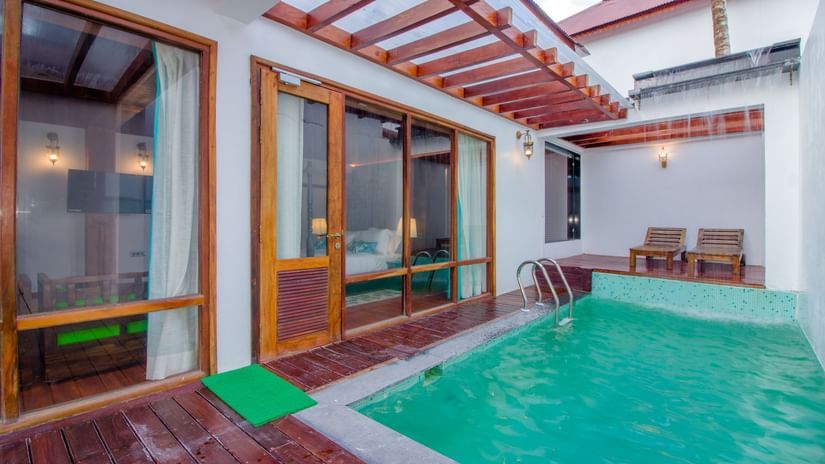 a swimming pool inside the Beach Mansion, an Andaman Luxury Pool Villa, with loungers in the background - Symphony Summer Sand Beach Resort And Spa, Neil Island.