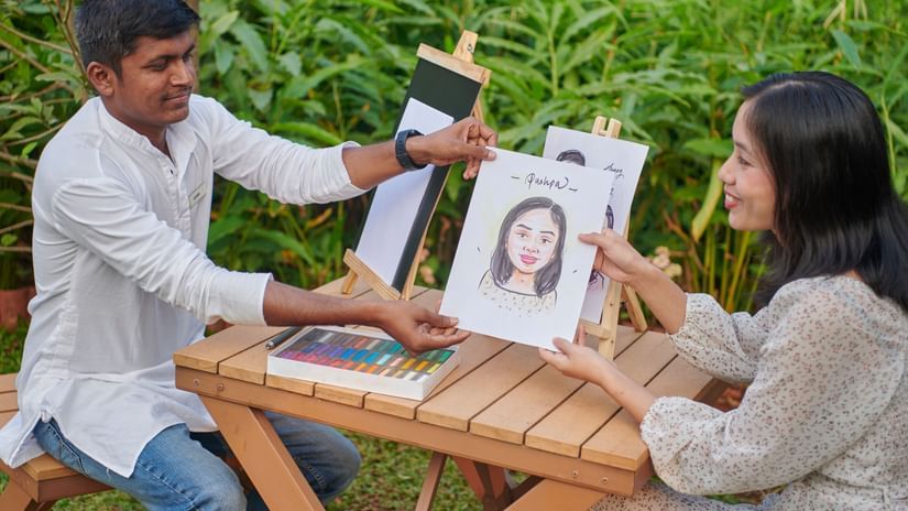  A person drawing a caricature of a woman on a piece of paper at The Dukes Retreat
