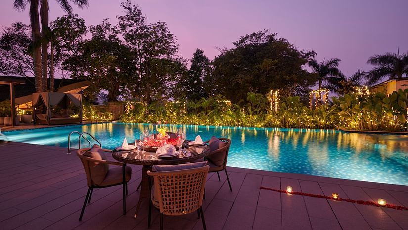Special dining setup by the swimming pool with candles at The Dukes Retreat