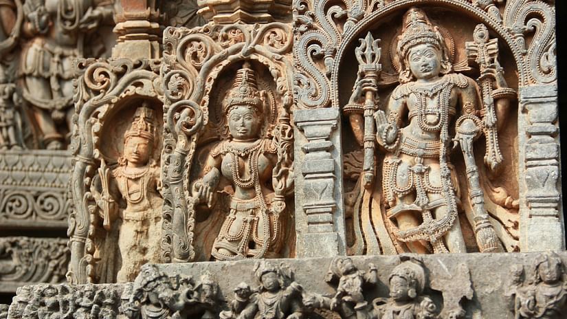 Carvings on wall of an ancient temple.
