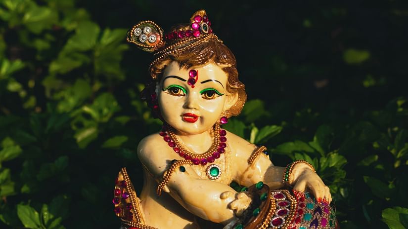 An idol of Lord Krishna with a pot in his hand