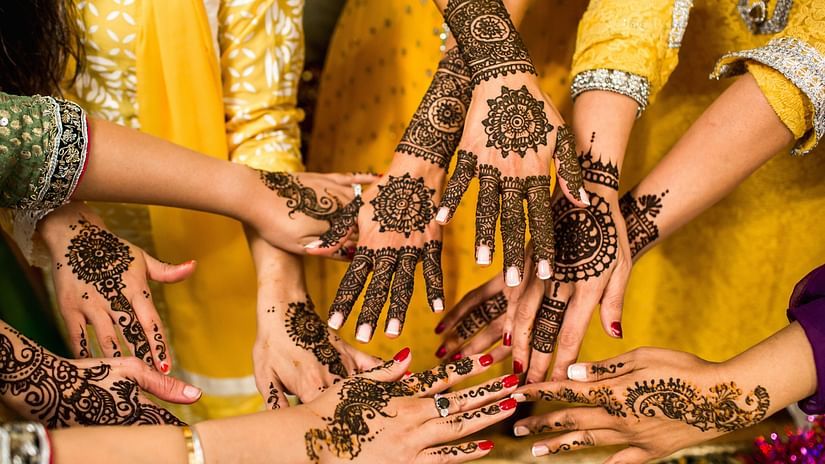 Women showing off their Mehendi painted hands during a Destination Wedding in Shimla