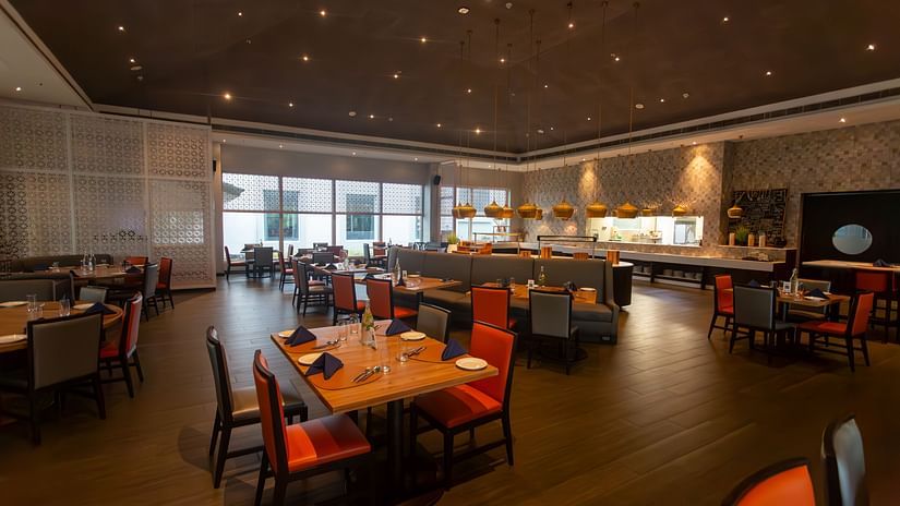 Restaurant featuring a wooden furnished chairs & table, a counter, and a starry ceiling at The Residency Towers Rameswaram
