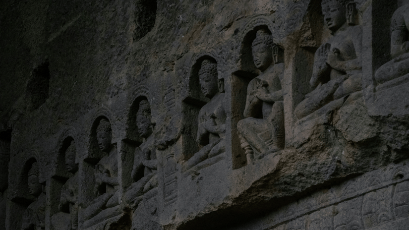 A close up of rock-cut sculptures at Kanheri Caves in Mumbai