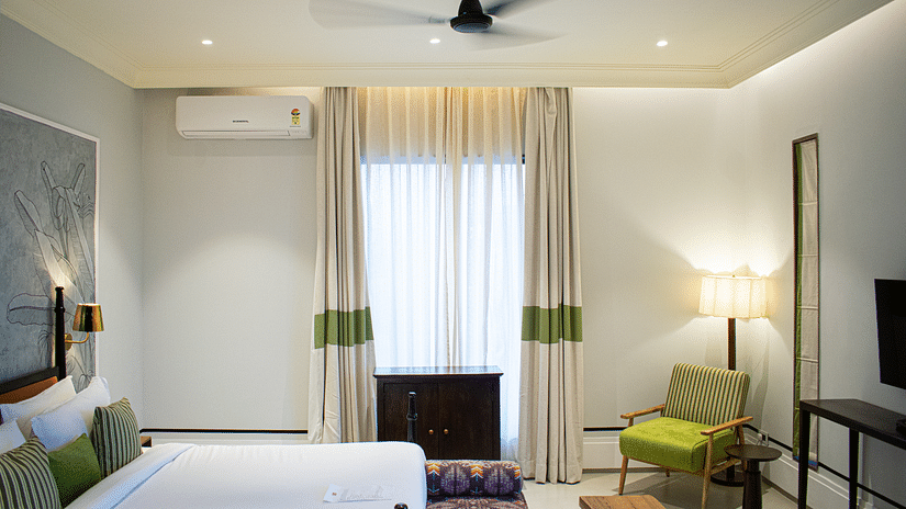 A bedroom's side view featuring a comfortable chair in the corner at The Sierra - By the Lake