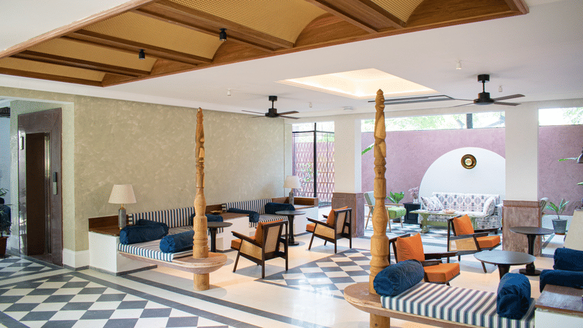 A spacious lobby with geometric floor patterns, traditional wooden accents, and a mix of contemporary and classic seating at The Sierra, Udaipur.
