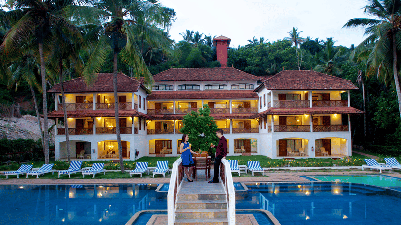 Facade of Beach Grove Room in front of a swimming pool at The Travancore Heritage Beach Resort