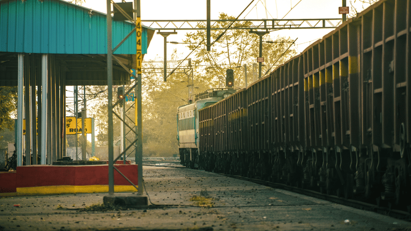 A train at an empty platform of a railway station on a misty day