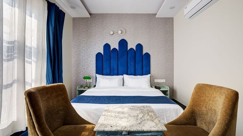 Superior Deluxe Room with blue themed interior and blue & white curtains - The White Moon