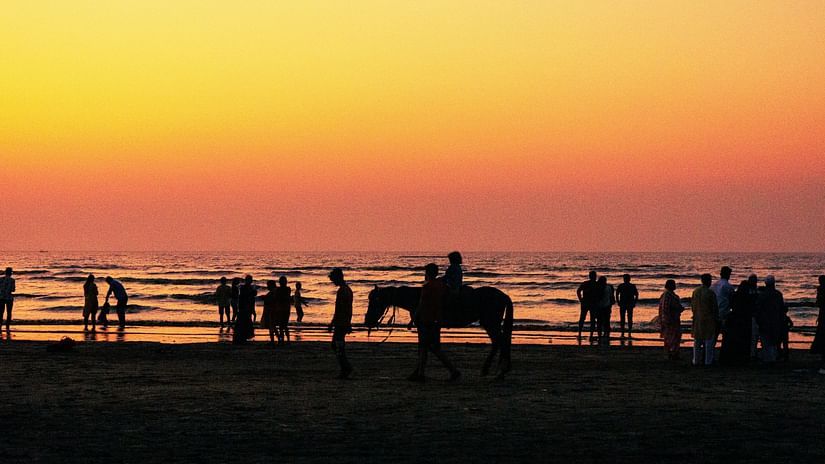 An overview of a beach in Daman with people