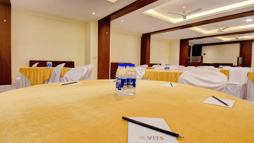 Conference table setup with notepads and water bottles at VITS Lonavala.