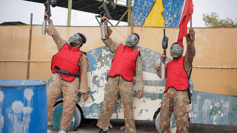 an image of three individuals holding paint ball guns in their hands and cheering at VITS Roccia Hill Resort & Adventure Parking.
