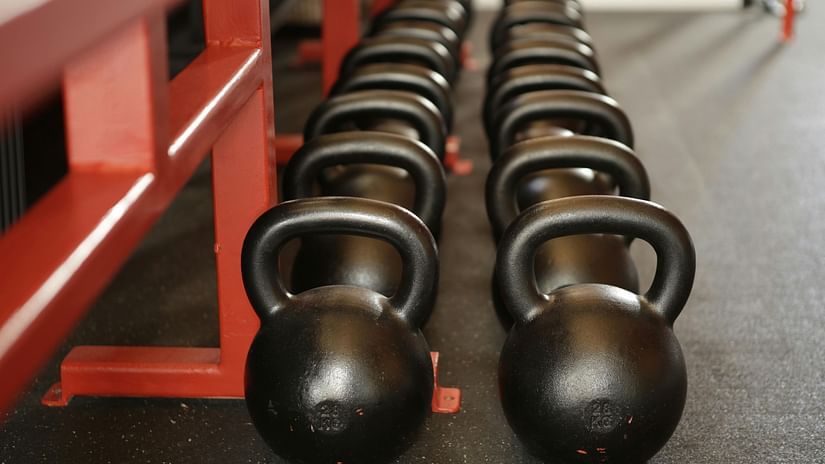 An image of neatly arranged dumbbells in a row.