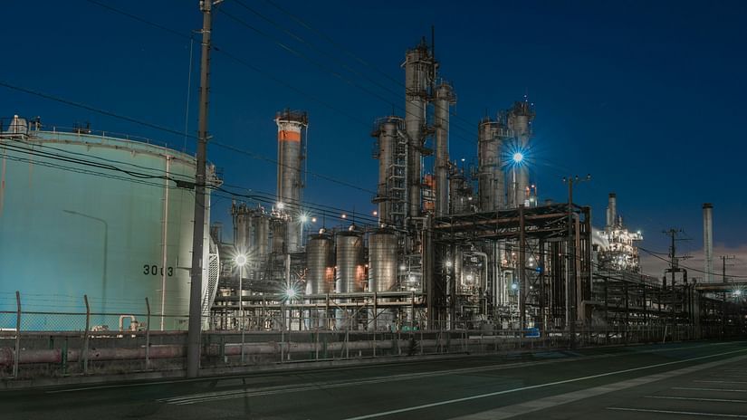 An overview of an industrial area during the night with the lights on.