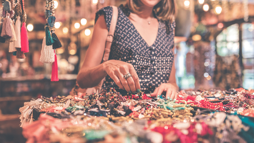 a woman looking at the various items on display to shop