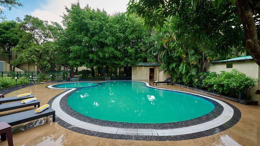 view of the pool and sun loungers at ABN Sarovar Portico, Jim Corbett