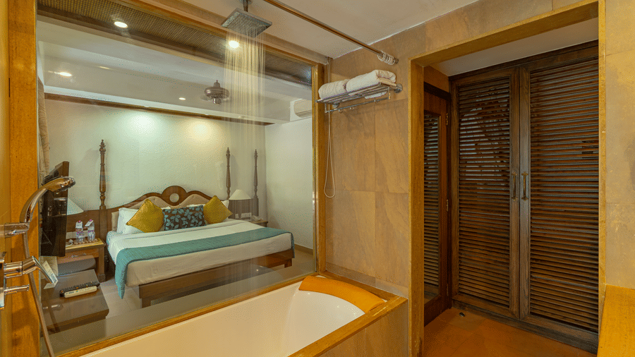 A view of a hotel room from inside of the bathroom with a bathtub.