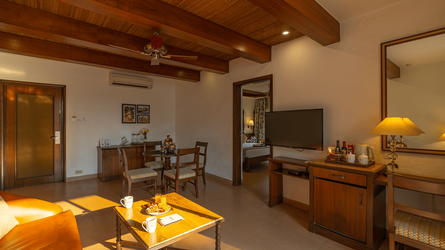 Living space of the suite rooms with balcony decorated with wooden furniture.