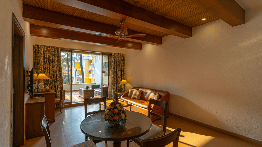 Living space of a hotel suite with a view of the balcony.