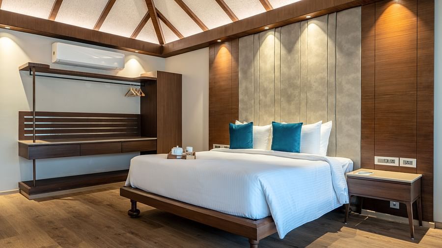 An image of a bedroom with double size bed and lights infused in the ceiling